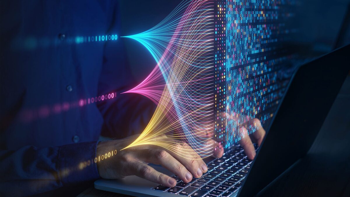 A person with a laptop, overlaid with binary data