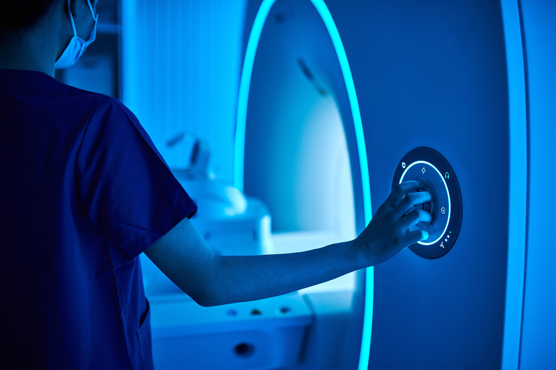 Female Nurse Operating MRI Scan Machine at MRI-scanner Room